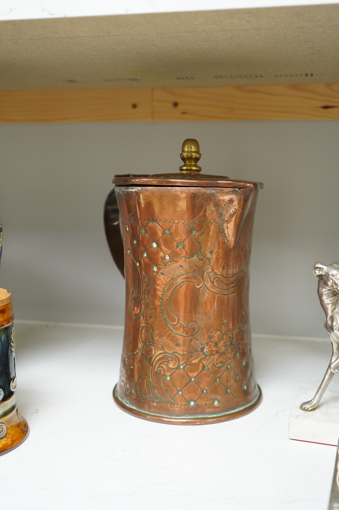 A pair of French Art Deco stag bookends, a chrome Greyhound mounted on a marble base, a large Arts and Crafts copper jug and two other items, jug 27cm high